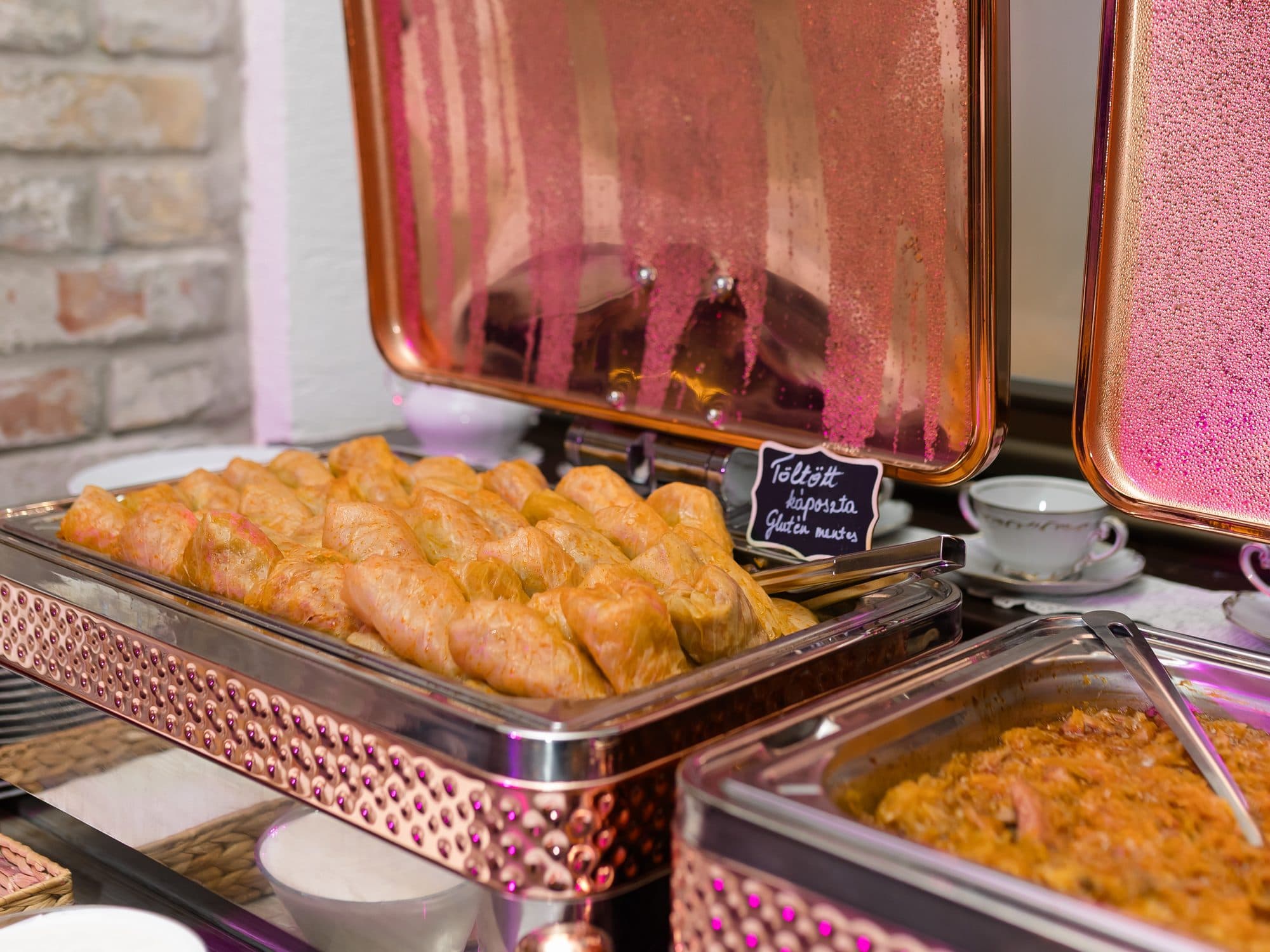 Stuffed cabbage in a chafing dish on the buffet, with a chalkboard label